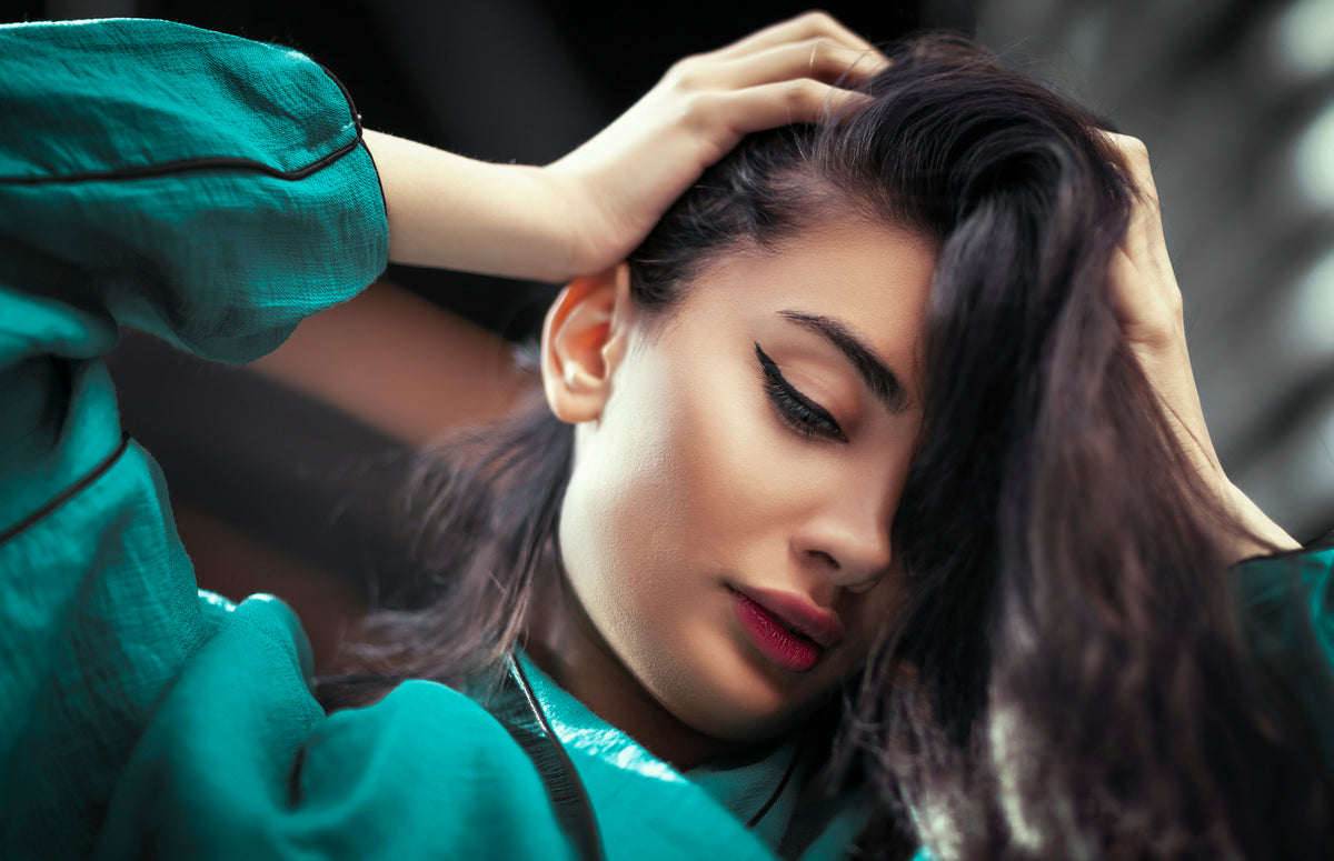 a woman with her hands on her head